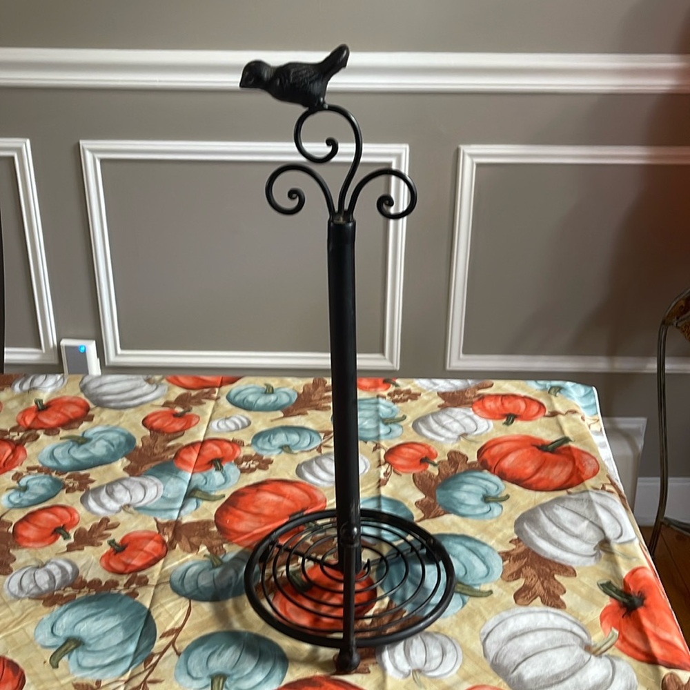 Metal paper towel holder with bird accent.